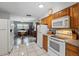 The kitchen features wood cabinets, tile floors, an oven, and ample counter space at 1111 Liberty Ave, Mount Dora, FL 32757