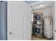 Convenient laundry room features stacked washer and dryer and a water heater, maximizing space efficiency at 1111 Liberty Ave, Mount Dora, FL 32757