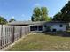Rear of home has a screened-in porch and spacious backyard area with a privacy fence surrounding the property at 11314 Huggins St, Leesburg, FL 34788