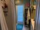 Bright bathroom featuring a shower, shelving, and a door to the outside at 11314 Huggins St, Leesburg, FL 34788