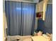 Bathroom with blue walls, white vanity, and combination shower and tub at 11314 Huggins St, Leesburg, FL 34788