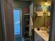 Bathroom with a white vanity, wall art, and a walk-in shower at 11314 Huggins St, Leesburg, FL 34788
