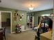 Bedroom featuring green walls, carpet, and an open doorway to another room at 11314 Huggins St, Leesburg, FL 34788