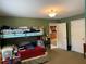 Green bedroom with bunkbeds, neutral carpet and trim, and open door at 11314 Huggins St, Leesburg, FL 34788