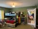Green bedroom with bunkbeds and a doorway to another room at 11314 Huggins St, Leesburg, FL 34788