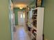 Hallway with tiled floors and white shelving units against the wall at 11314 Huggins St, Leesburg, FL 34788