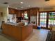 Bright kitchen featuring granite countertops, wooden cabinets, and stainless appliances at 11314 Huggins St, Leesburg, FL 34788