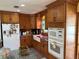 Spacious kitchen featuring stainless appliances, granite counters, and wooden cabinets at 11314 Huggins St, Leesburg, FL 34788
