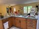 Kitchen with granite countertops, stainless appliances, and wooden cabinets at 11314 Huggins St, Leesburg, FL 34788
