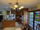 Kitchen with stainless appliances, wooden cabinetry, granite counters, and tile floors at 11314 Huggins St, Leesburg, FL 34788