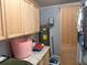 Spacious laundry room featuring a water heater, storage, and granite countertop at 11314 Huggins St, Leesburg, FL 34788