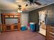 Comfortable living room featuring a large entertainment center and access to the laundry room at 11314 Huggins St, Leesburg, FL 34788