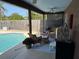 Outdoor patio with a pool view, lounge furniture, and ceiling fan at 11314 Huggins St, Leesburg, FL 34788