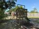 Backyard wooden playground structure with swings and slide for outdoor enjoyment at 11314 Huggins St, Leesburg, FL 34788