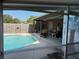 View of the pool and outdoor patio area from the screened porch at 11314 Huggins St, Leesburg, FL 34788