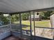 Screened porch featuring a view of the backyard and storage shed at 11314 Huggins St, Leesburg, FL 34788