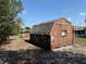 Backyard shed structure provides functional storage for home improvement and gardening equipment at 11314 Huggins St, Leesburg, FL 34788