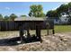 Well pump area features a wooden covering with tools, buckets, and other household objects at 11314 Huggins St, Leesburg, FL 34788