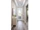 Elegant foyer with decorative glass front door, stylish cabinet, and wood-look floors at 131 Addle Hill Ct, Deland, FL 32720