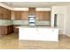 Modern kitchen with stainless steel appliances, wooden cabinets, backsplash, and center island at 131 Addle Hill Ct, Deland, FL 32720