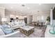 Stylish living room with modern furniture, an open floorplan, and direct access to the kitchen and dining area at 131 Addle Hill Ct, Deland, FL 32720