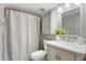Bathroom features a marble vanity, updated fixtures, a shower with a curtain, and coordinated decor at 141 Lewfield Circle # 141, Winter Park, FL 32792