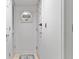 Hallway with white walls, doors, and a decorative mirror, creating a clean and bright space at 141 Lewfield Circle # 141, Winter Park, FL 32792