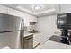 Galley kitchen featuring stainless steel appliances, bright white cabinets, and updated countertops at 141 Lewfield Circle # 141, Winter Park, FL 32792