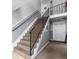 Stairwell with carpeted steps and black railing leading to the upper level of the building, creating an inviting entrance at 141 Lewfield Circle # 141, Winter Park, FL 32792