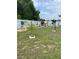 The backyard is grass-covered and partially fenced with decorative potted plants at 1620 Hialeah St, Orlando, FL 32808