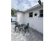 Outdoor seating area with a table and chairs on a paved patio perfect for entertaining at 1620 Hialeah St, Orlando, FL 32808