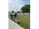 Expansive backyard with lush greenery, a paved area, and various garden features at 1620 Hialeah St, Orlando, FL 32808