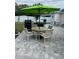 Paved patio features an umbrella-covered table, chairs, and outdoor cooking equipment at 1620 Hialeah St, Orlando, FL 32808