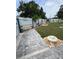 Spacious backyard featuring a patio, lush green lawn, and a charming white fence at 1620 Hialeah St, Orlando, FL 32808