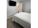 A bedroom with a TV mounted on the wall and the entrance to the bathroom at 1620 Hialeah St, Orlando, FL 32808
