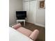 Bedroom with a view of the TV, closet, and pink chaise lounge at 1620 Hialeah St, Orlando, FL 32808