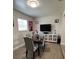 Cozy dining area features a table with four chairs and a tv at 1620 Hialeah St, Orlando, FL 32808