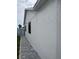 Exterior of home showing well-maintained stucco and side path at 1620 Hialeah St, Orlando, FL 32808