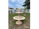 Outdoor water fountain with decorative doves adds charm to the lush backyard of this home at 1620 Hialeah St, Orlando, FL 32808