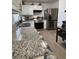 The kitchen features granite countertops, stainless steel appliances, and white cabinets at 1620 Hialeah St, Orlando, FL 32808