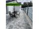 Paved patio features outdoor exercise equipment and an umbrella-covered table with chairs at 1620 Hialeah St, Orlando, FL 32808
