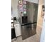 Kitchen features a stainless steel refrigerator, granite countertops, and white cabinetry at 1620 Hialeah St, Orlando, FL 32808