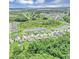 Aerial view of homes nestled near ponds and agricultural fields under a blue sky at 16406 Blooming Cherry Dr, Groveland, FL 34736