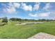 Expansive backyard with a serene pond view, perfect for relaxation at 16406 Blooming Cherry Dr, Groveland, FL 34736