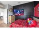 Bedroom featuring sports flag decor and a black accent wall at 16406 Blooming Cherry Dr, Groveland, FL 34736