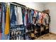Spacious walk-in closet with organized shelving and hanging rods for clothing and accessories at 16406 Blooming Cherry Dr, Groveland, FL 34736