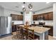 Stylish kitchen featuring a spacious island with seating, granite countertops, and stainless steel appliances at 16406 Blooming Cherry Dr, Groveland, FL 34736