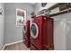Laundry room featuring a window and like-new, stacked washer and dryer units at 16406 Blooming Cherry Dr, Groveland, FL 34736