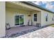 Covered patio with sliding door and brick accents at 16406 Blooming Cherry Dr, Groveland, FL 34736