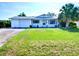 Charming single-story home features a well-manicured front lawn, attached garage, and classic curb appeal at 1670 Clematis Ln, Winter Park, FL 32792